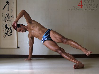 Balnacing in side plank with hips lifted and top foot lifted. Neil Keleher. Sensational Yoga Poses.