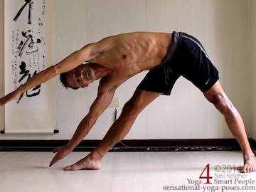 Yoga triangle pose with both arms reaching past the head to the side, neil keleher, sensational yoga poses.