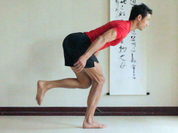 warrior 3 vinyasa, knee bent, arms back, weight centered on standing foot.