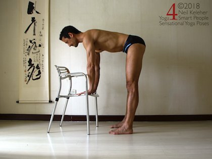 Standing forward bend using a chair. Neil Keleher. Sensational Yoga Poses.