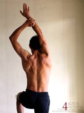 Arm overhead shoulder stretch, pulling one arm to the inside, neil keleher, sensational yoga poses.