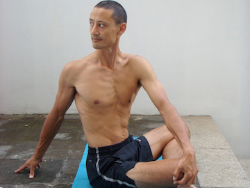 Low back stretches: cross legged easy twist using the arms. Neil Keleher, sensational Yoga poses.