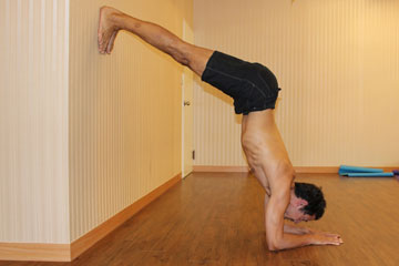 pincha mayurasana with a wall