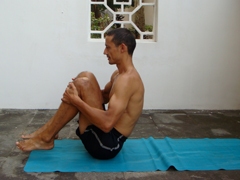 rolling on the back with spine rounded as a preparation for plow pose and shoulder stand and as an ab exercise. In this picture I'm balanced on sitting bones prior to rolling back (and after rolling forwards).