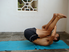 rolling back 2, rolling on the back with spine rounded as a preparation for plow pose and shoulder stand and as an ab exercise. In this picture I'm balancing over the center or mid point of my back (midway between head and pelvis.)