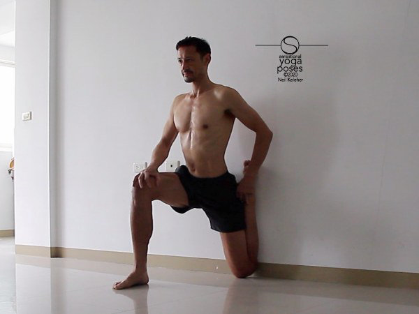 quad stretch using a wall with hips and torso pressing towards wall. Neil Keleher, Sensational Yoga Poses.