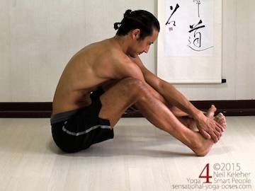 One option for stretching between the shoulder blades is to sit with feet hip width apart and knees slightly bent. Cross the arms and grab the opposite foot with both arms. Pull the ribcage back, away from the feet to stretch the shoulders. Move torso up or down to vary the stretch. Neil Keleher. Sensational Yoga Poses.