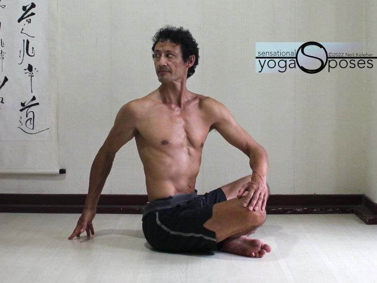 Low back stretches: cross legged easy twist using the arms. Neil Keleher, sensational Yoga poses.