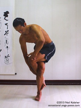 Sensational Yoga Poses, Model Neil Keleher. balancing on one leg while crossing the legs and ankles fully for eagle pose. The foot is hooker around the ankle of my standing leg.