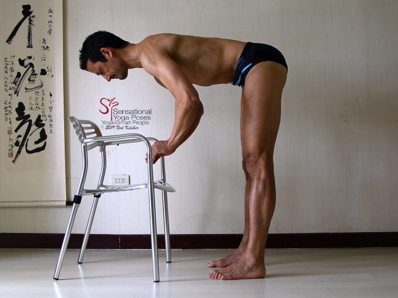 Standing forward bend with hamstrings engaged so that they support the weight of the upper body so that hands can be lifted. Neil Keleher, Sensational Yoga Poses.