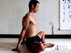 Bound angle pose upright with hands on the floor behind the hips.