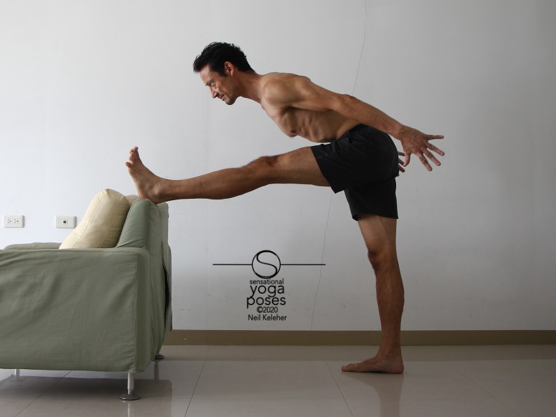 Standing hamstring stretch with one leg supported and stretched. Neil Keleher, Sensational Yoga Poses.
