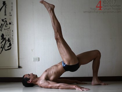 Leg strengthening exercises for the glutes: pushing one foot into the floor and lifting the other foot while in bridge pose. Neil Keleher. Sensational Yoga Poses.