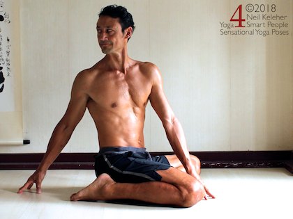bharadvajasana seated twist variation. basic yoga sequence for flexibility,  combined quad stretch and spinal twist.