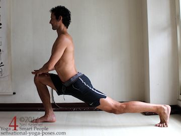 high lunge hip flexor stretch with both hands on front knee, back foot toes tucked under.