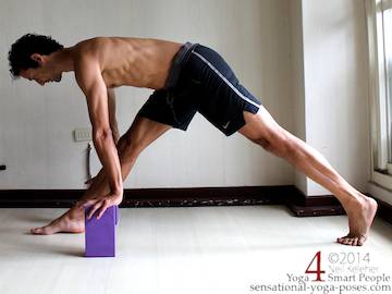 standing hamstring stretch with one leg forward, other leg back with hands on yoga blocks, elbows straight.