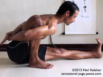 Marichyasana A from side, can see hand grabbing wrist behind back.