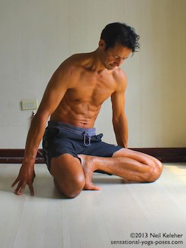 kneeling with one foot in janu sirsasana c postion as a preparation for marichyasana b