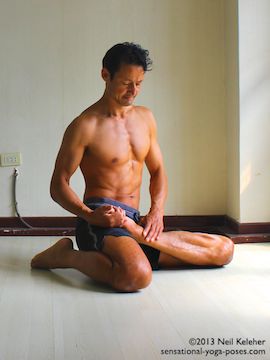 pulling foot into lotus with other leg in kneeling position as a preparation for marichyasana b