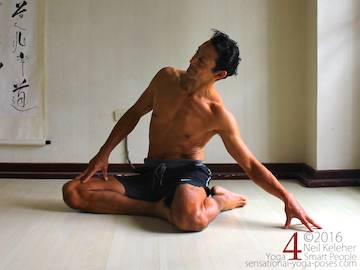 easy bharadvajasana side bend (towards kneeling leg) with hand resting on the floor.