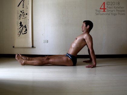 Reverse plank pose prep position with hips down but spine bent backwards Neil Keleher. Sensational Yoga Poses.