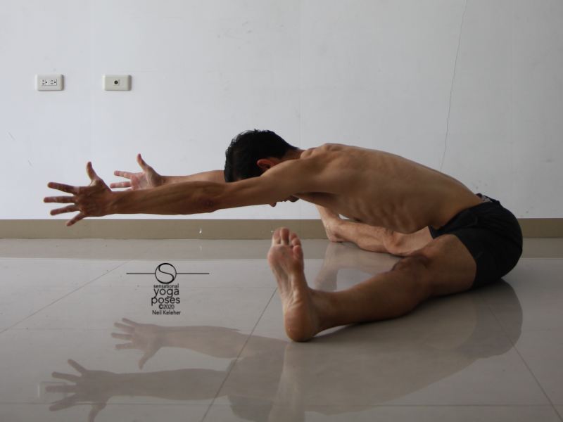 wide leg forward bend, knees straight, reaching forwards with hands off of floor, yoga pose