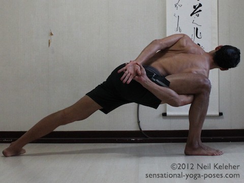 side angle pose, side angle yoga pose with arms bound behind the bck