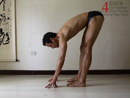 Standing forward bend, hips shifted rearwards, weight over heels. Neil Keleher. Sensational Yoga Poses.