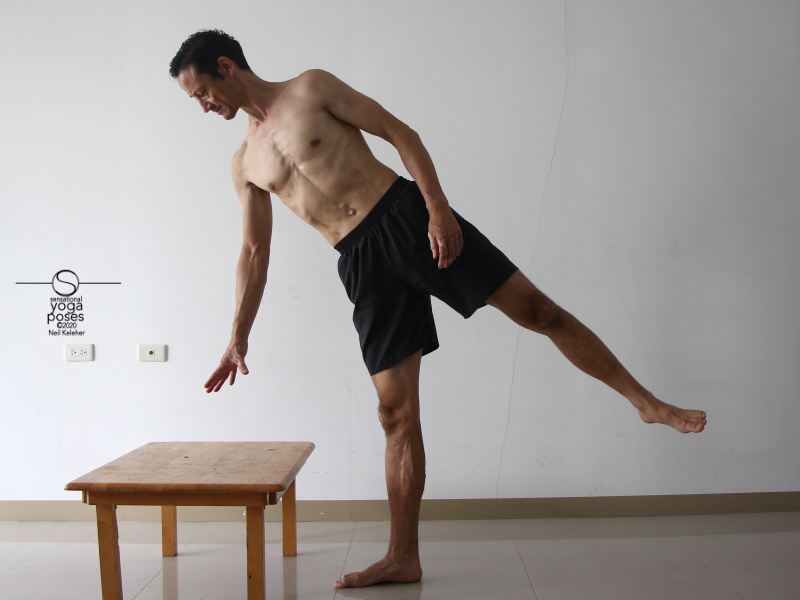 Using half moon yoga pose to stretch the hamstrings. Neil Keleher, Sensational Yoga Poses.