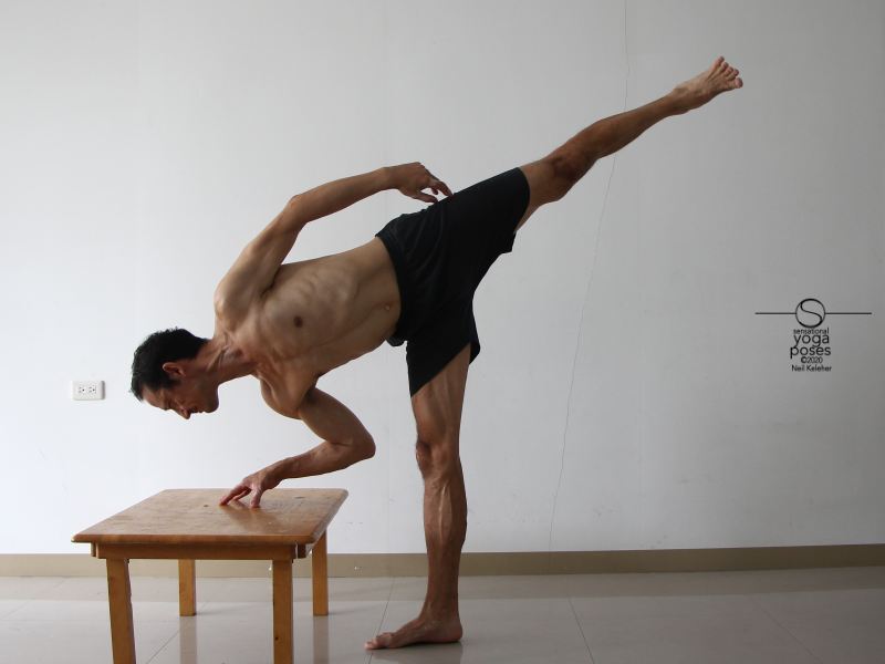 Using half moon yoga pose to stretch the hamstrings. Neil Keleher, Sensational Yoga Poses.