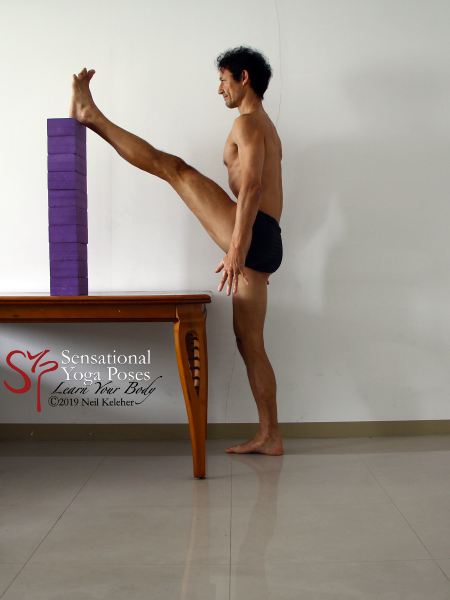 One way to increase the stretch to the hamstrings with a foot on a table is to use more yoga blocks. neil keleher. sensational yoga poses.