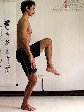 utthita hasta padangusthasana prepration, standing on one leg, other knee lifted