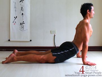 upward dog hip flexor stretch with tops of feet flat on the floor.